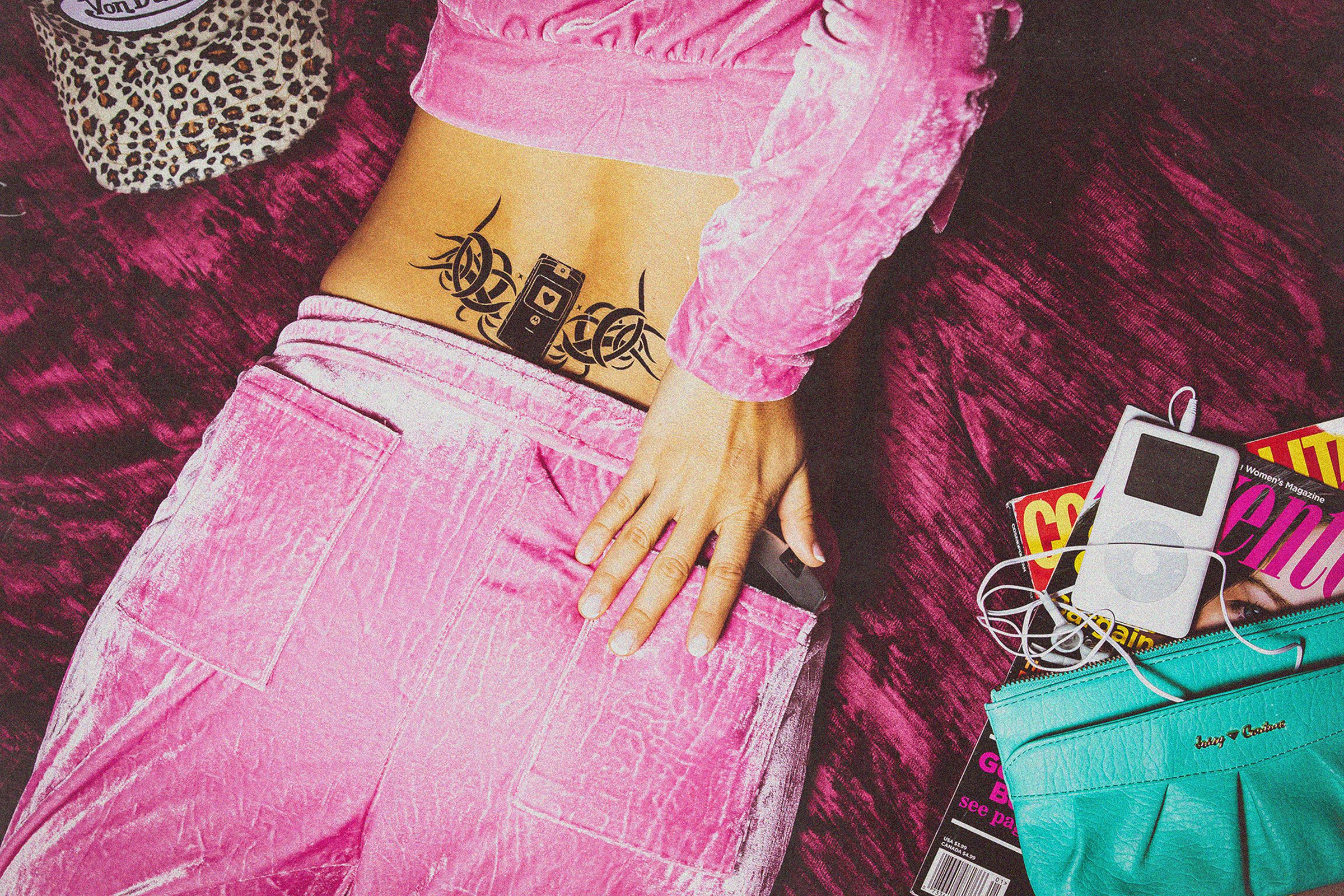 A woman in a velour track suit reaching in her back pocket for her Motorola Razr. She has a tribal Motorola Razr tattoo on her lower back.