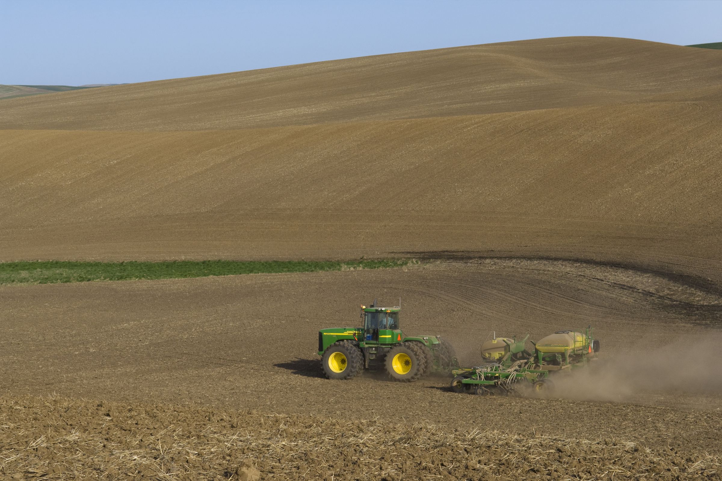 A tractor seen driving through a field.