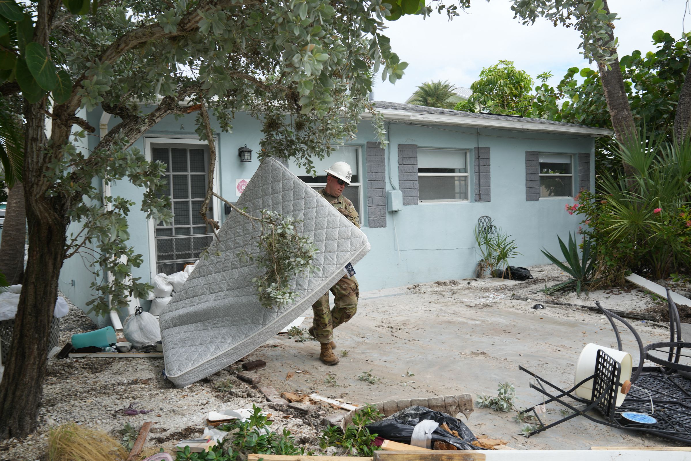 A Florida Army National Guard member works to remove debris in the Pass-A-Grille section of St. Petersburg ahead of Hurricane Milton’s expected landfall in the middle of this week on October 7th, 2024, in Florida.