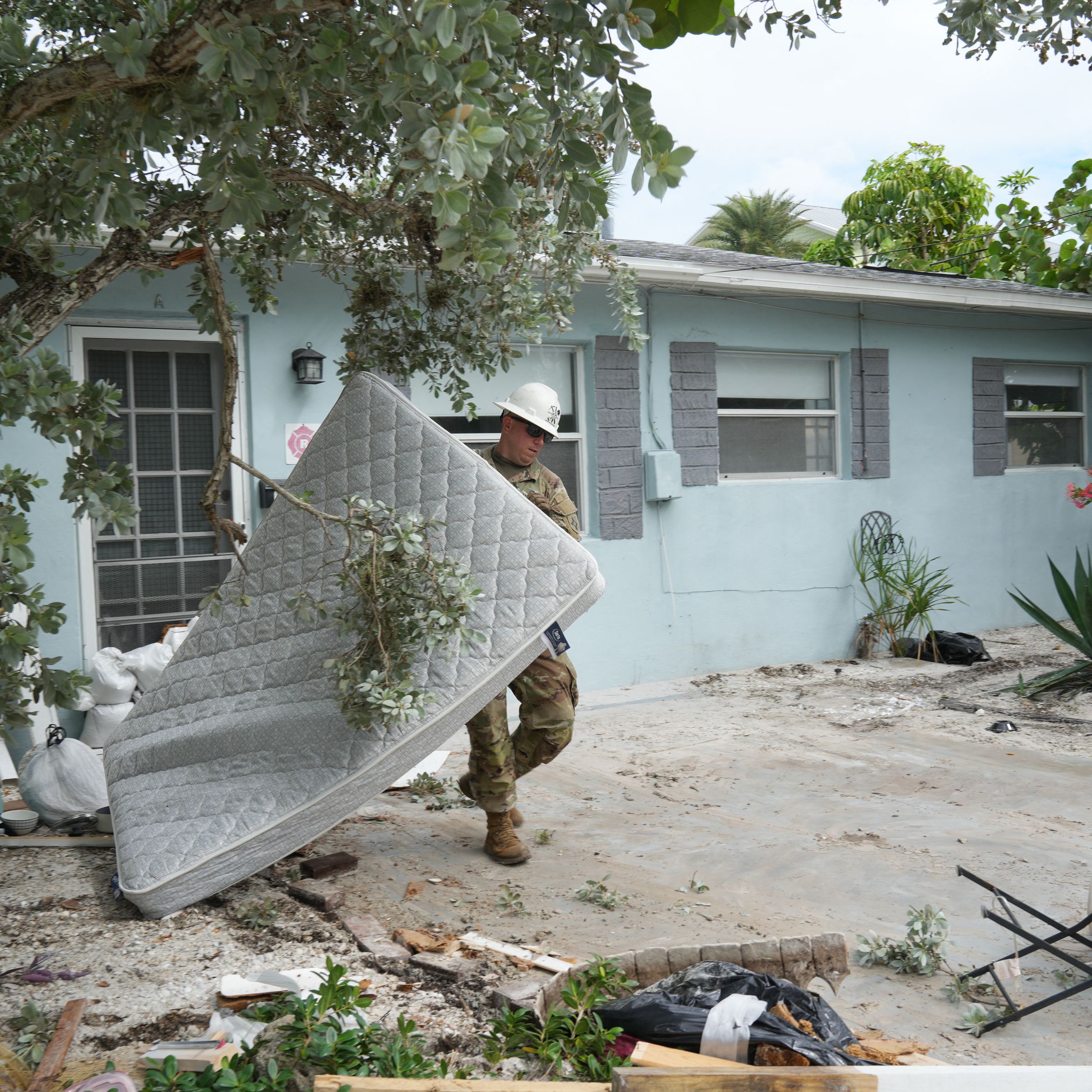 A Florida Army National Guard member works to remove debris in the Pass-A-Grille section of St. Petersburg ahead of Hurricane Milton’s expected landfall in the middle of this week on October 7th, 2024, in Florida.
