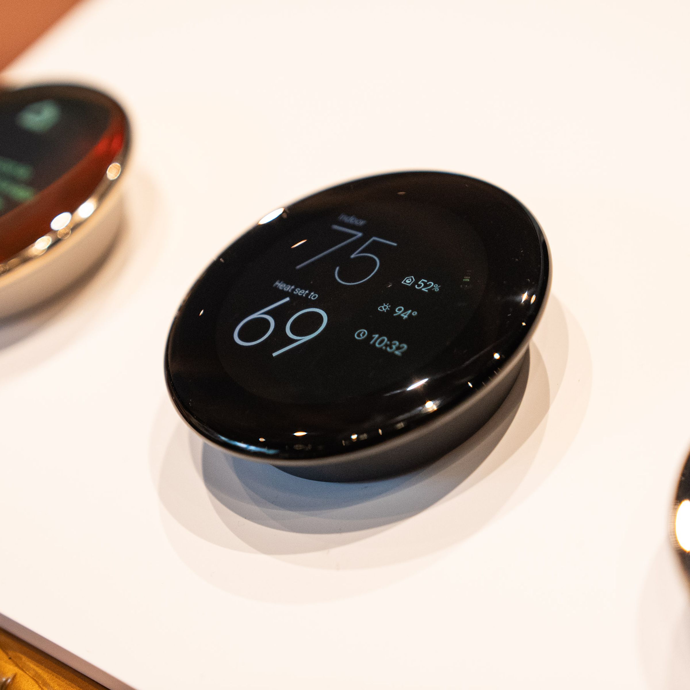 A lineup of fourth-gen Google Nest Learning Thermostats mounted on a display board.