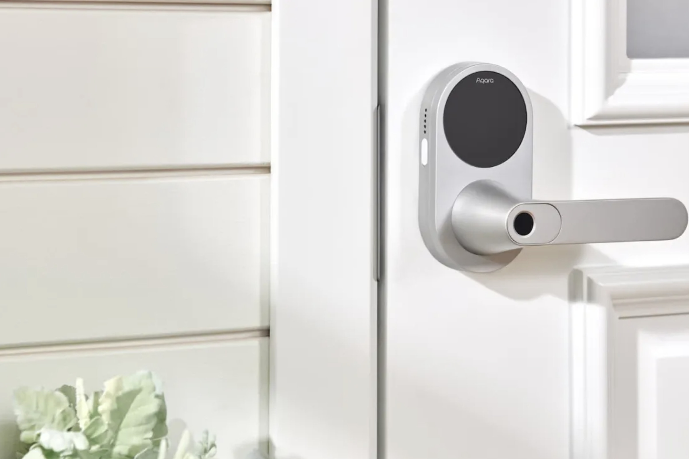Aqara’s U300 smart lever lock installed on a white exterior door.