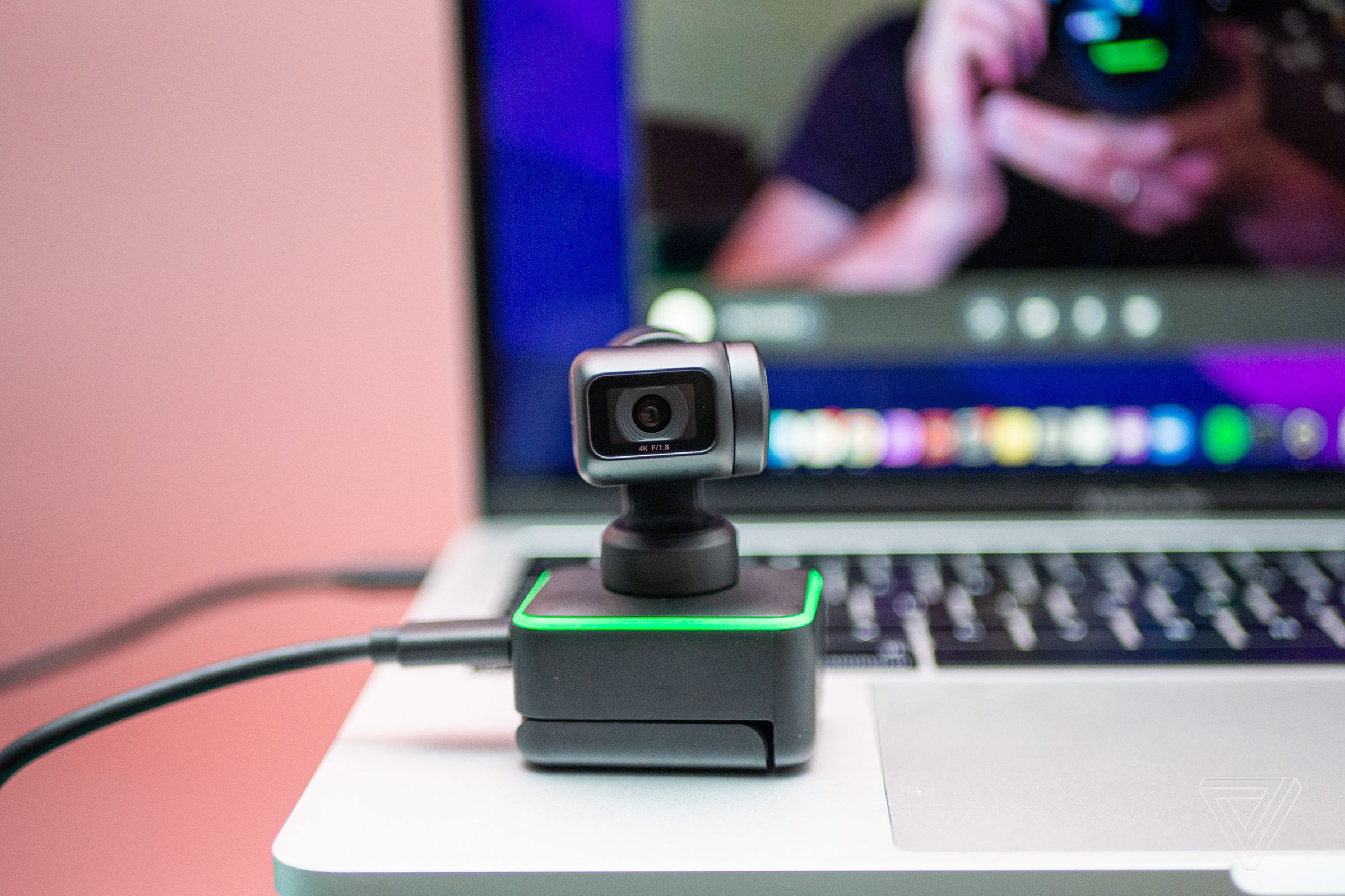 The Insta360 Link webcam resting on a laptop.