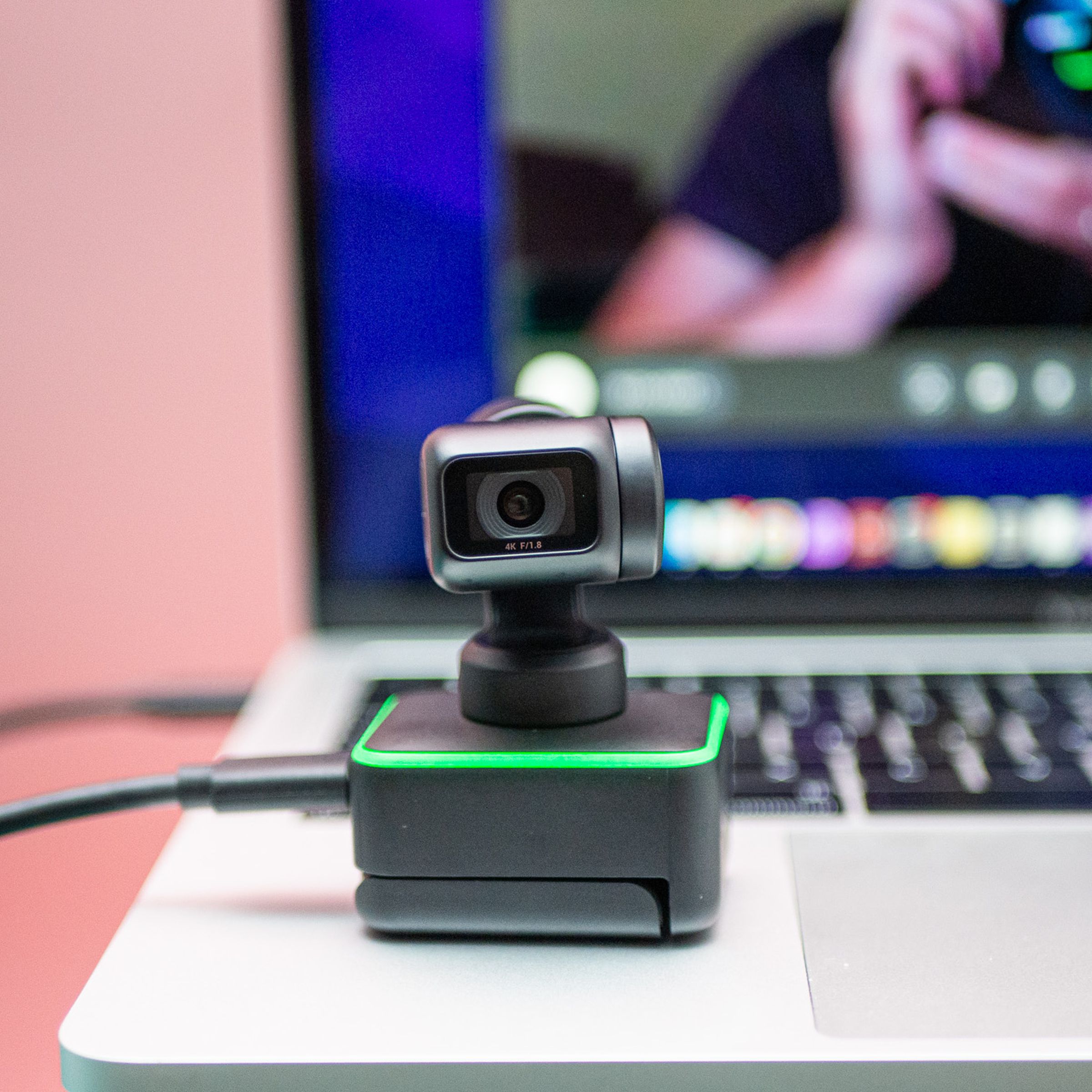 The Insta360 Link webcam resting on a laptop.