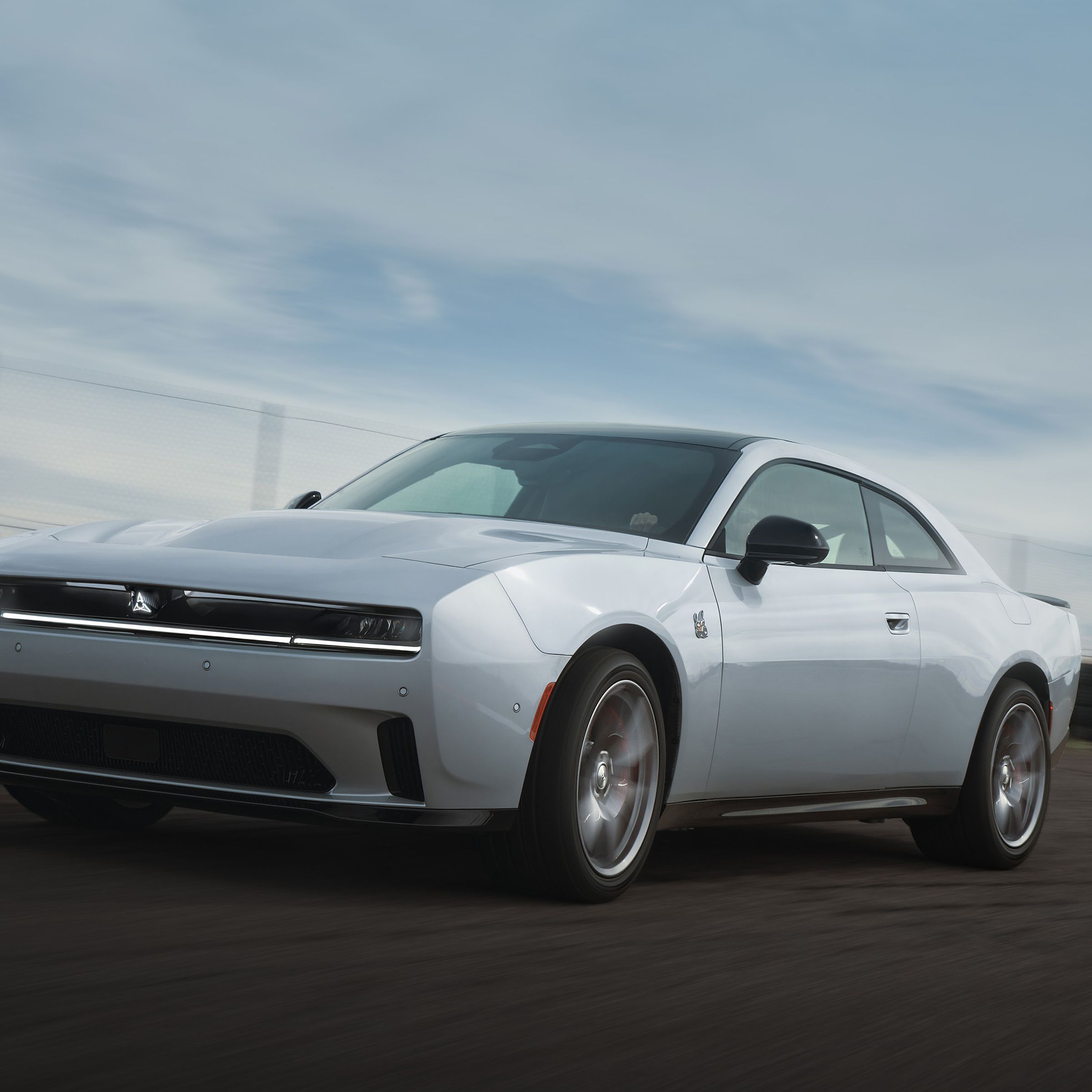 silver two-door muscle car on a track