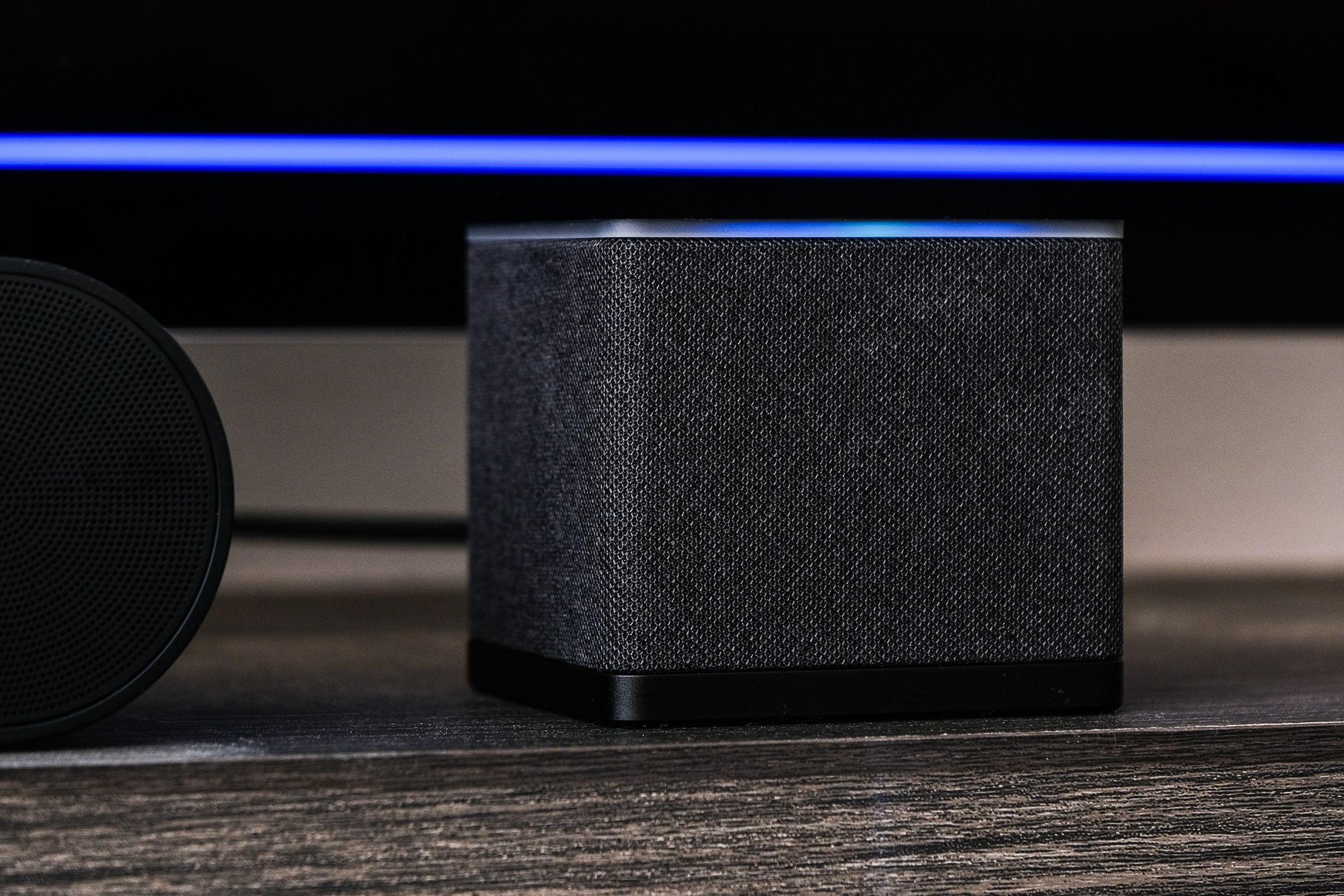 A photo of Amazon’s Fire TV Cube on a TV stand.