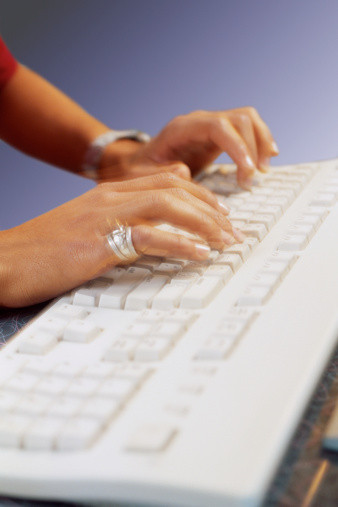 Woman typing on keyboard