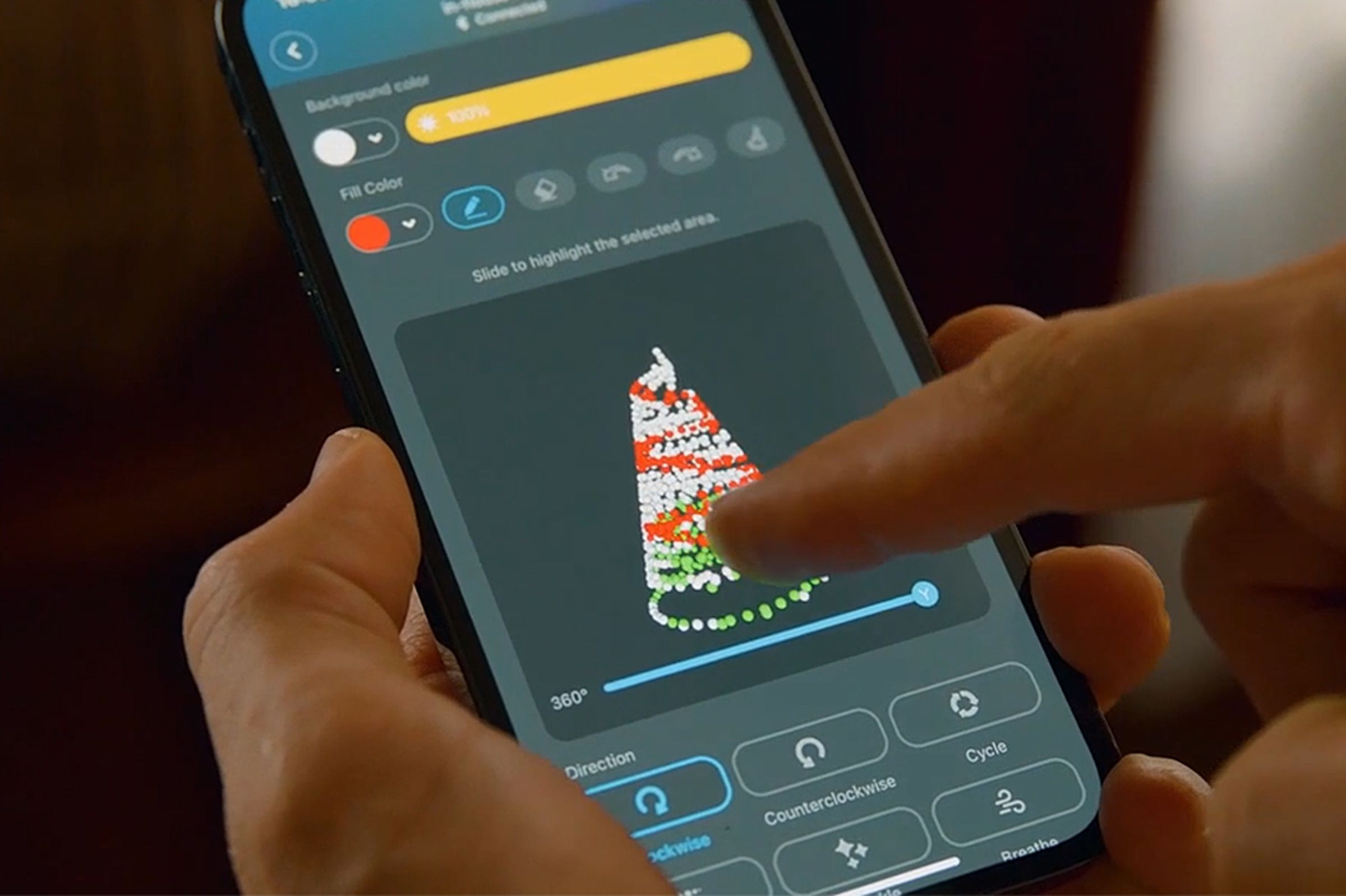 A user draws a custom lighting design for a Christmas tree inside the Govee smartphone app.