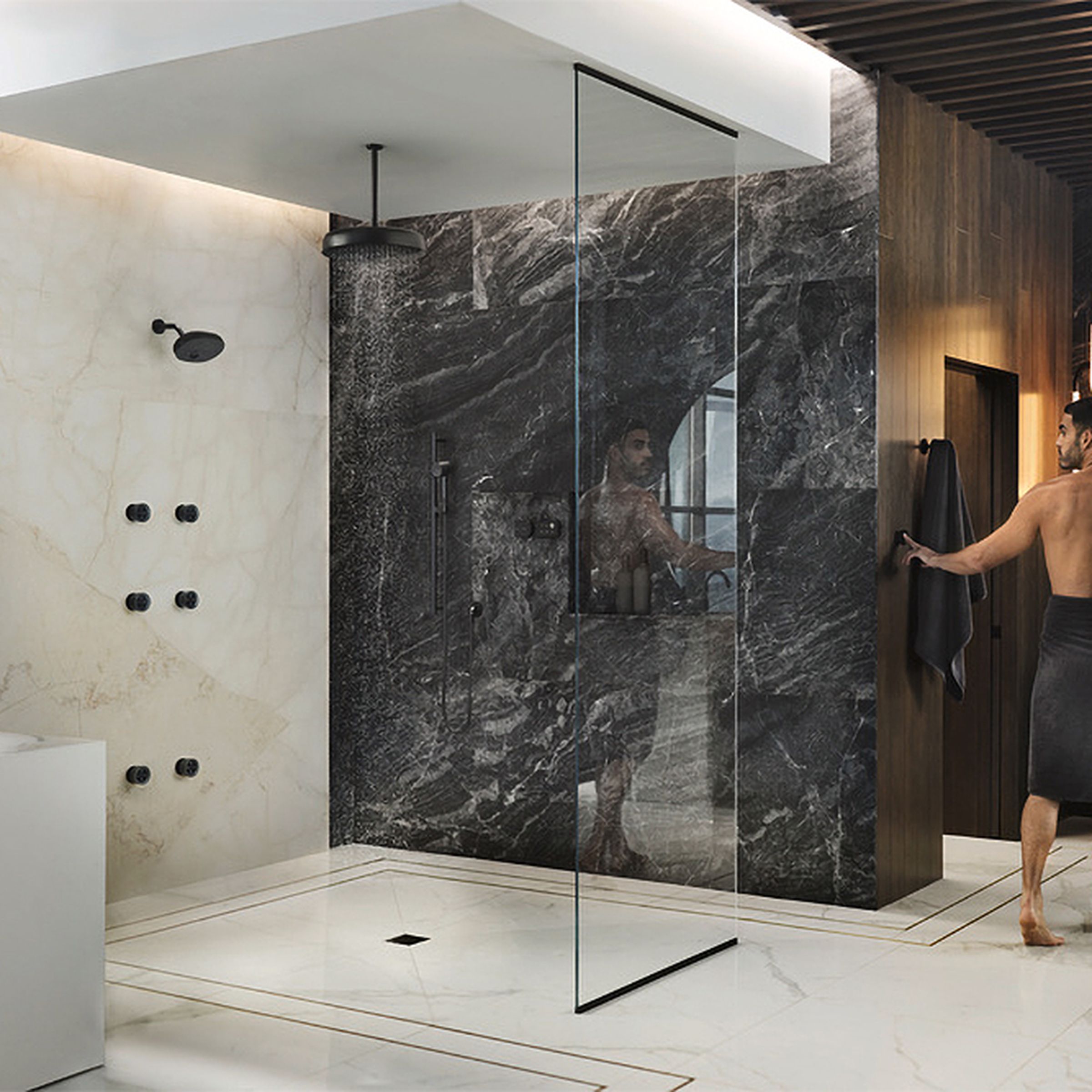 A person uses a wall-mounted controller to active a Kohler Anthem smart show installation.