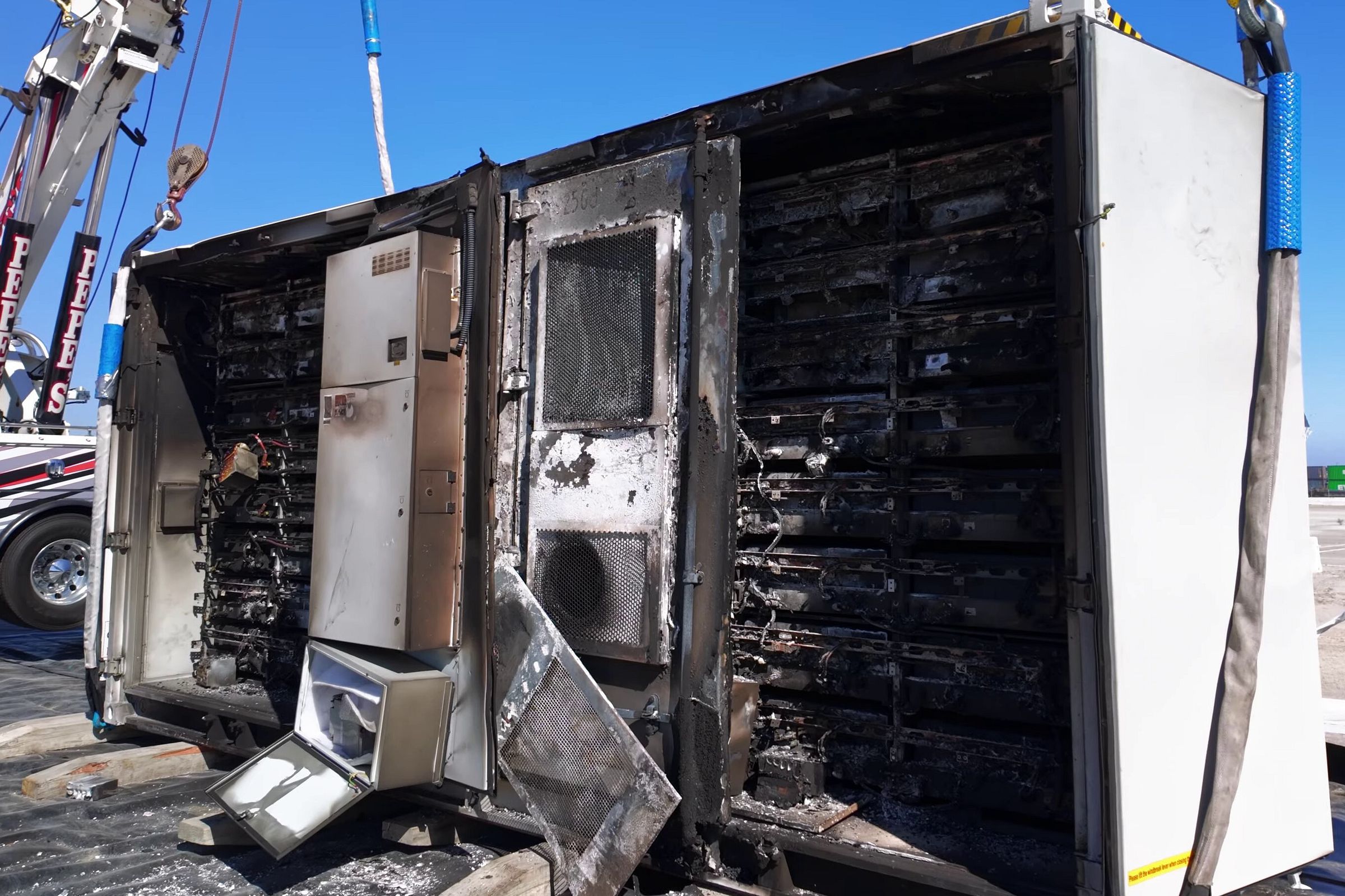 burnt batteries in a white truck container