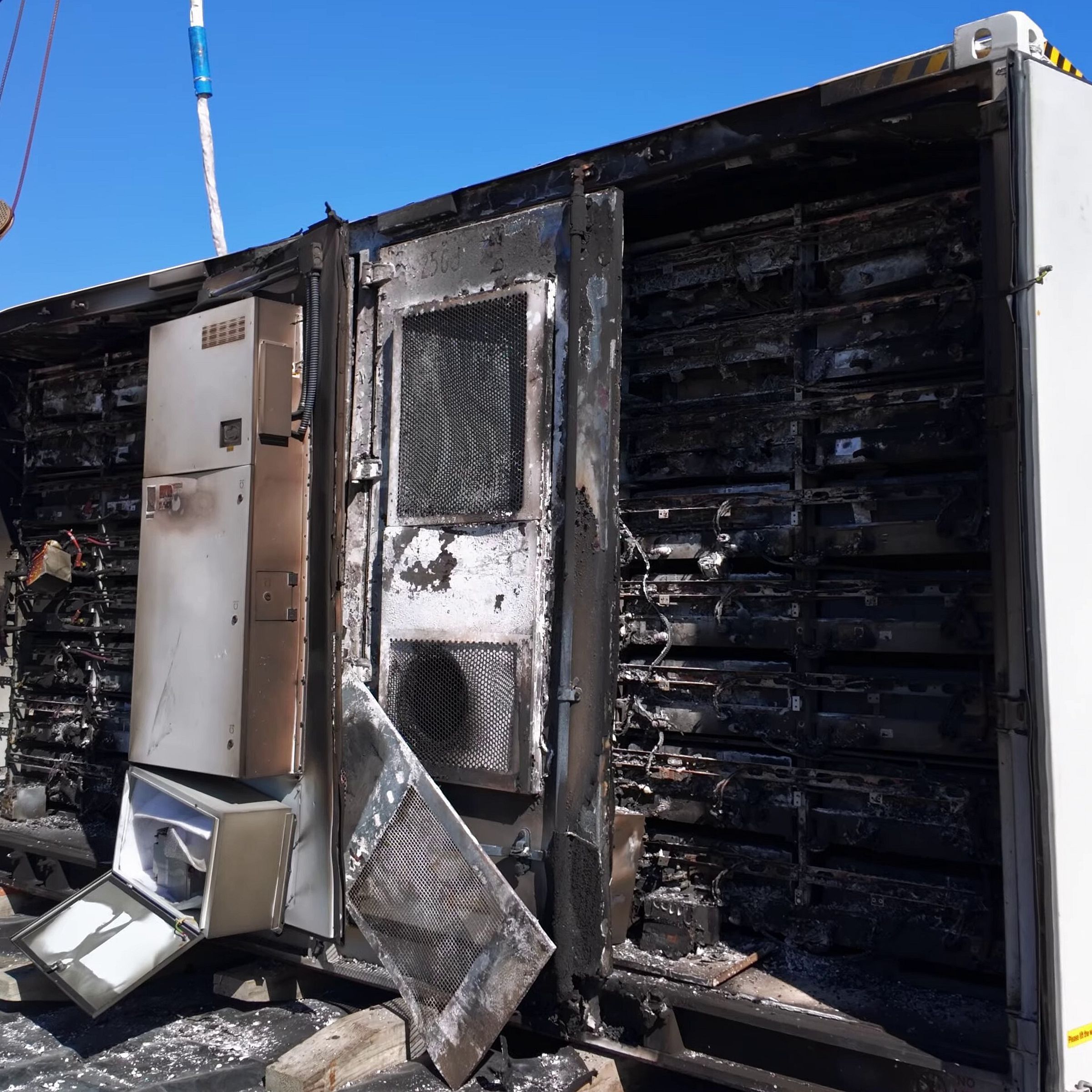 burnt batteries in a white truck container