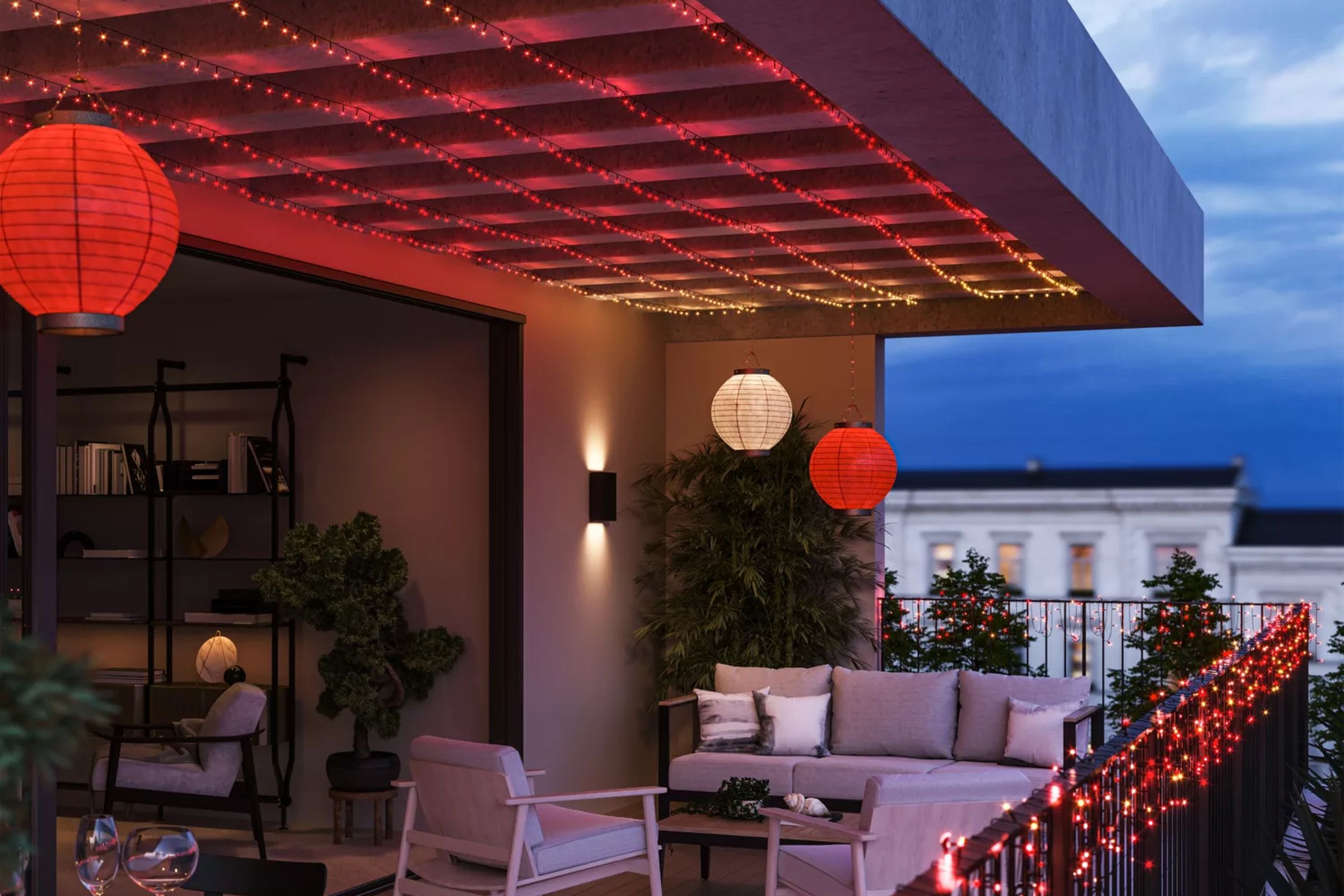 Philips Hue’s Festavia string lights strung up on a fence and on the Christmas tree.