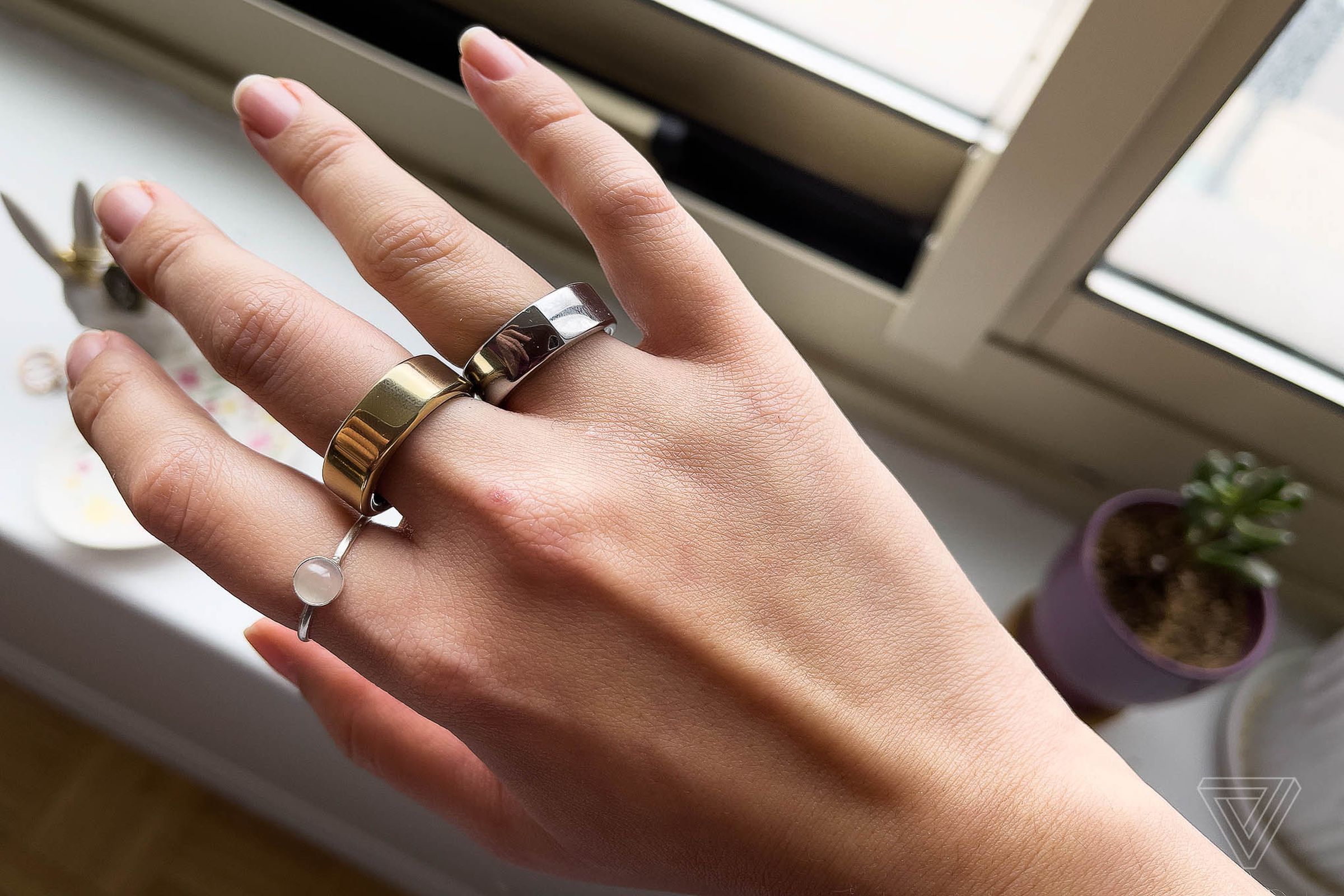 A normal ring, the Oura Ring Gen 3 (center), and the Oura Ring Gen 2 (left)